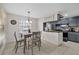 Dining room with a wooden table set, bright window, stylish light fixture, and tile floors at 8724 Mallard Reserve Dr # 101, Tampa, FL 33614