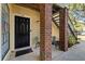 Charming condo entrance with brick pillars, seating, and well-maintained landscaping at 8724 Mallard Reserve Dr # 101, Tampa, FL 33614