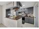 Charming kitchen features gray cabinetry, wood countertops, stainless steel appliances, and tile flooring at 8724 Mallard Reserve Dr # 101, Tampa, FL 33614
