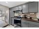 Modern kitchen with stainless steel appliances, gray cabinetry and attractive backsplash at 8724 Mallard Reserve Dr # 101, Tampa, FL 33614