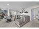 Comfortable living room with a plush gray sectional sofa and chair with a round mirror and tile floors at 8724 Mallard Reserve Dr # 101, Tampa, FL 33614