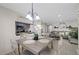 Dining room featuring table, chairs, chandelier, and open view to living room and kitchen at 8724 Mallard Reserve Dr # 101, Tampa, FL 33614