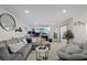 Bright living room with a comfortable gray sofa, fireplace, accent chair and tile flooring at 8724 Mallard Reserve Dr # 101, Tampa, FL 33614