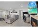 Open concept living room with fireplace, TV, sectional sofa, and view of the bedroom at 8724 Mallard Reserve Dr # 101, Tampa, FL 33614