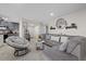 Living room showcasing gray sectional sofa, round chair, tile flooring and neutral decor at 8724 Mallard Reserve Dr # 101, Tampa, FL 33614