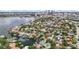 An aerial view of the property in a waterfront neighborhood, with city skyline views and convenient access to the bay at 90 Bahama Cir, Tampa, FL 33606