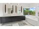 Elegant bathroom with double vanity, soaking tub, and scenic window view at 90 Bahama Cir, Tampa, FL 33606