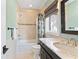 Bright bathroom with a shower and marble countertop at 90 Bahama Cir, Tampa, FL 33606