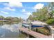 Boat on lift at private dock with water views and easy access to waterway at 90 Bahama Cir, Tampa, FL 33606