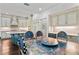 Open floorplan showcasing a painted dining table, island, and modern white cabinets at 90 Bahama Cir, Tampa, FL 33606