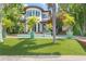 Beautiful home exterior with a pool, lush greenery, and inviting outdoor living spaces at 90 Bahama Cir, Tampa, FL 33606