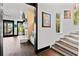 View of foyer with hardwood floors, staircase, and doorway leading to a bright living area at 90 Bahama Cir, Tampa, FL 33606