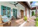 Inviting front porch with comfortable seating and double doors at 90 Bahama Cir, Tampa, FL 33606