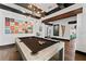 Bright game room featuring a modern pool table, art, and access to other rooms at 90 Bahama Cir, Tampa, FL 33606
