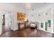 Hallway featuring dark wood floors, white walls, decorative art, and a curved banister at 90 Bahama Cir, Tampa, FL 33606