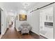 Hallway with barn door, wood floors and chair at 90 Bahama Cir, Tampa, FL 33606