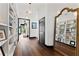 Bright hallway features dark wood floors, white walls, recessed lighting, and a built-in bookshelf display at 90 Bahama Cir, Tampa, FL 33606
