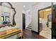 Hallway features hardwood floors, stylish decor, and a glimpse into the laundry room at 90 Bahama Cir, Tampa, FL 33606
