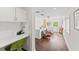 Bright hallway features built-in desk, hardwood floors, and a cozy sitting area with plenty of natural light at 90 Bahama Cir, Tampa, FL 33606
