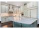 Bright kitchen features white cabinets, a contrasting island, and luxurious marble countertops at 90 Bahama Cir, Tampa, FL 33606