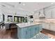 Spacious open-concept kitchen with blue kitchen island and seamless flow to the living room at 90 Bahama Cir, Tampa, FL 33606