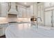 Bright kitchen features custom cabinetry, stainless steel appliances, and a large island with a stone countertop at 90 Bahama Cir, Tampa, FL 33606