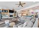 Open living space with fireplace, TV, sofa, kitchen view, and access to the backyard at 90 Bahama Cir, Tampa, FL 33606