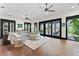 Large living room featuring hardwood floors, neutral decor, and expansive windows with views at 90 Bahama Cir, Tampa, FL 33606