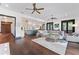 Open-concept living area showcasing hardwood floors, a comfortable sofa, and an adjacent kitchen at 90 Bahama Cir, Tampa, FL 33606