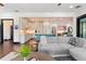 Open-concept living space showcasing hardwood floors, a comfortable sofa, and an adjacent kitchen at 90 Bahama Cir, Tampa, FL 33606