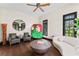 Comfortable living room featuring hardwood floors, modern sofa, accent chairs, and artistic decor at 90 Bahama Cir, Tampa, FL 33606