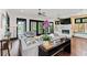 Spacious living room with hardwood floors, fireplace, and sliding glass doors to outdoor space at 90 Bahama Cir, Tampa, FL 33606