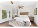 Main bedroom features hardwood floors and a bench at the end of the bed at 90 Bahama Cir, Tampa, FL 33606