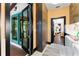 Mudroom featuring built-in storage, access to the laundry, and exterior access with teal doors at 90 Bahama Cir, Tampa, FL 33606