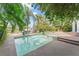 This beautiful pool features a sun shelf, spa, lush landscaping, and waterway views at 90 Bahama Cir, Tampa, FL 33606