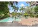The backyard oasis features a pool, spa, lush landscaping, and boat dock with serene waterfront views at 90 Bahama Cir, Tampa, FL 33606