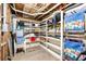 Basement storage room with shelves, various gear, and wooden walls at 9048 Wharf Ave, Placida, FL 33946