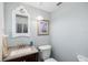 Powder room with white fixtures, granite counters, and stylish fixtures at 9048 Wharf Ave, Placida, FL 33946