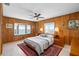 Bedroom boasts a charming bay window with water view, wood paneling, and ample closet space at 9048 Wharf Ave, Placida, FL 33946