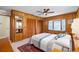 Bedroom boasts a charming bay window with water view, wood paneling, and ample closet space at 9048 Wharf Ave, Placida, FL 33946