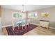 Bright dining room with decorative rug, glass table, and natural lighting at 9048 Wharf Ave, Placida, FL 33946