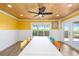 Bright dining room with wood paneled ceiling, view of outdoor area, large table, and colorful chairs at 9048 Wharf Ave, Placida, FL 33946