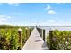 Long dock with an American flag leading to a beautiful bay underneath blue skies with puffy white clouds at 9048 Wharf Ave, Placida, FL 33946