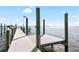 Dock leading into bay underneath a blue sky with puffy white clouds with an American flag at 9048 Wharf Ave, Placida, FL 33946