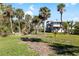 Property with lush landscaping, palm trees, and a fire pit at 9048 Wharf Ave, Placida, FL 33946
