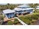 Aerial view of home showcasing expansive decks, screened porches and waterfront access at 9048 Wharf Ave, Placida, FL 33946