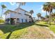 Lovely beach house featuring a backyard with palm trees and a patio on the stilts at 9048 Wharf Ave, Placida, FL 33946
