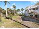 Coastal home with well-maintained grounds, complemented by lush landscaping and swaying palm trees at 9048 Wharf Ave, Placida, FL 33946