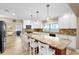 Open kitchen features an island with seating, granite countertops, and lots of cabinet space at 9048 Wharf Ave, Placida, FL 33946