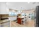 Bright kitchen features an island with seating and views into the comfortable living room at 9048 Wharf Ave, Placida, FL 33946